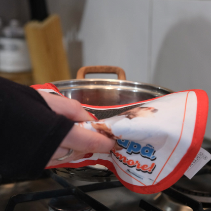 Presina da cucina personalizzabile FotoGrafica con bordo rosso, utilizzata per afferrare una pentola sui fornelli