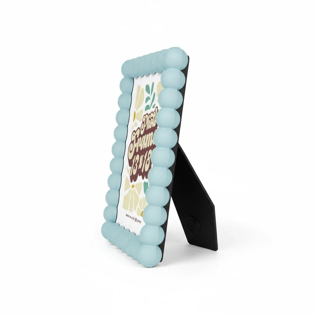 Cornice portafoto da tavolo FotoGrafica azzurra con bordo a sfere decorative e supporto posteriore nero