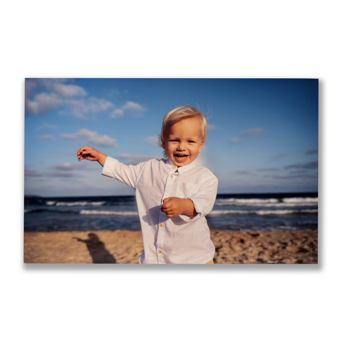 FotoGrafica pannello in forex con stampa di un bambino sorridente in camicia bianca sulla spiaggia al tramonto